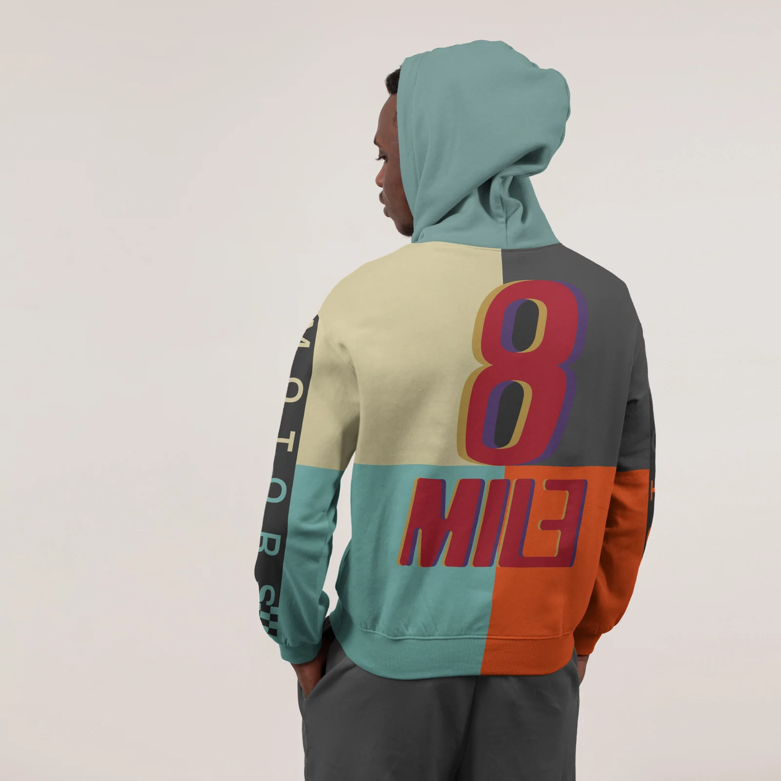 Colour-blocked hoodie mockup with the full-colour 8 Mile Motors logo on the back.