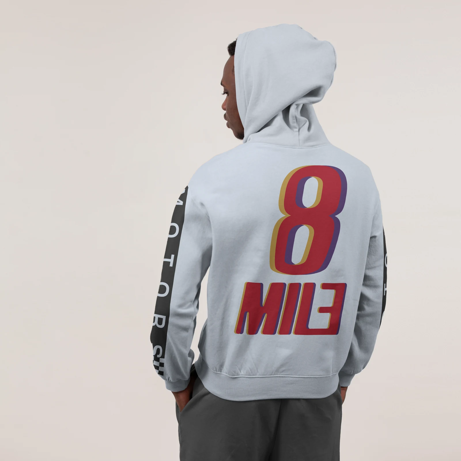 Light grey hoodie mockup carrying the full-colour 8 Mile Motors logo on the back.